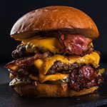 Burger. Double cutlet, double cheddar cheese, bacon, deep-fried onions, pickles, sauce and craft bun.