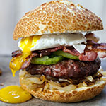 Beef burger with bacon and poached egg