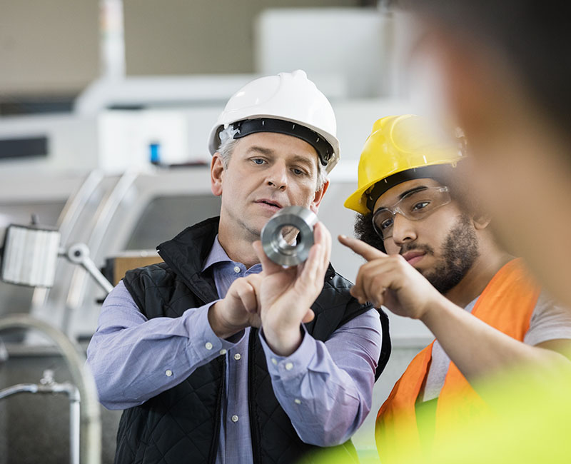 Supervisor and manual worker discussing