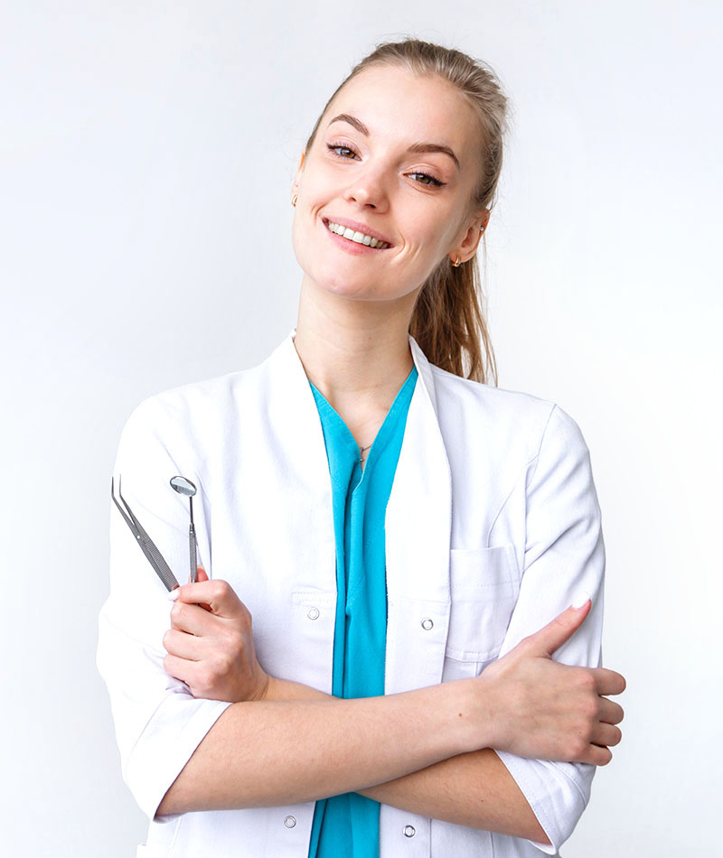 Young female dentist wearing in uniform with tweezers and mirror isolated on white
